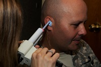 Soldier getting a mold taken of his ear for a hearing aid