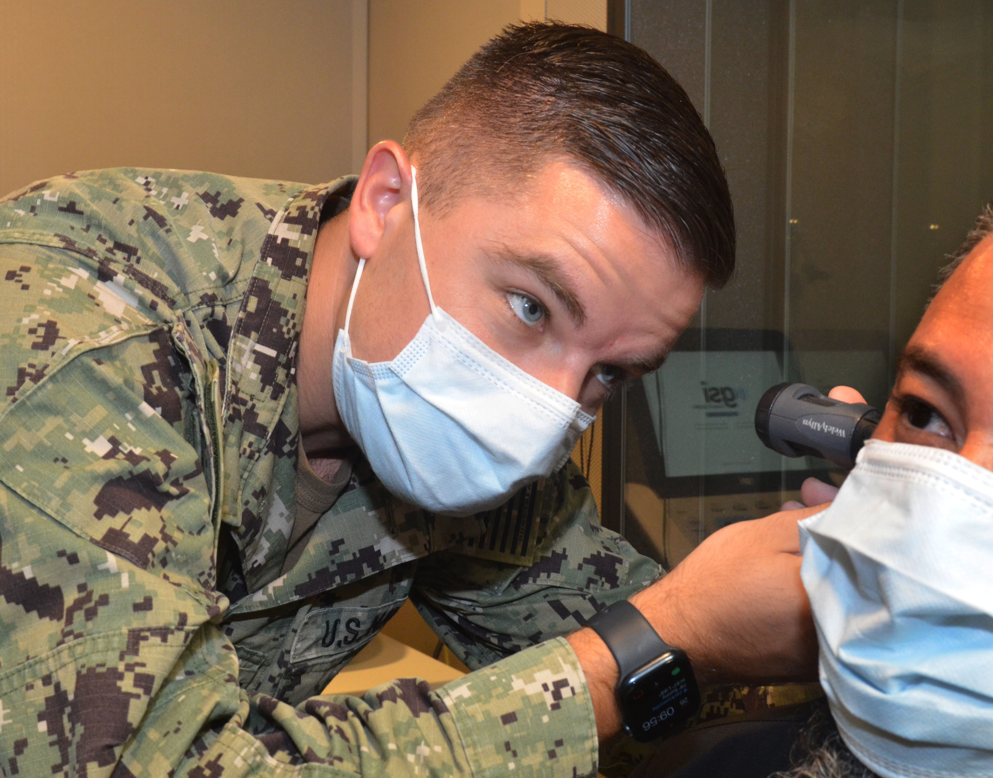 U.S. Navy Lt. Kyle Rodgers, an occupational audiologist at Naval Branch Health Clinic Jacksonville, uses an otoscope to conduct an ear exam.  (U.S. Navy photo by Deidre Smith, Naval Hospital)