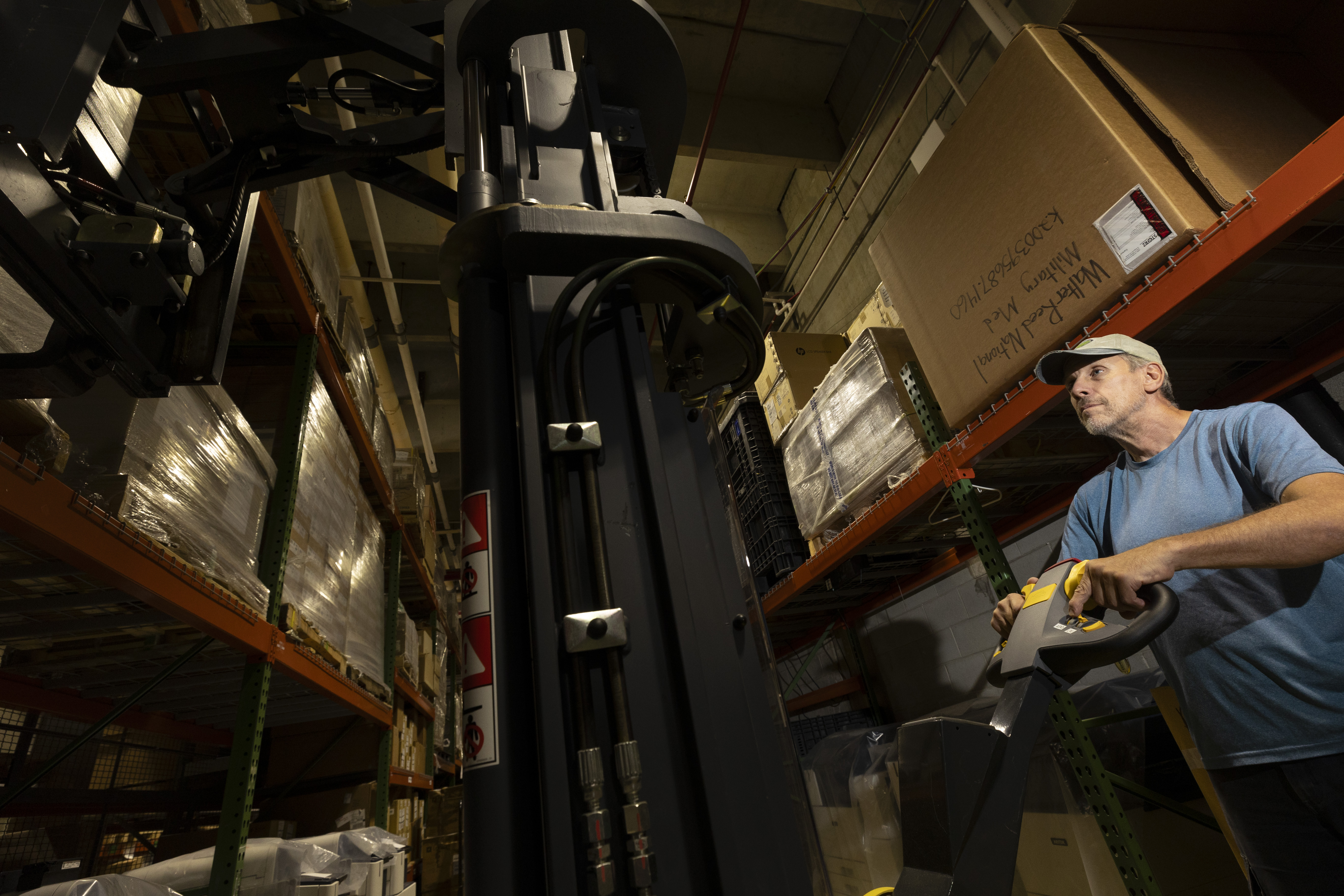David Burnett, a civilian material handler at Walter Reed National Military Medical Center in Bethesda, Maryland, operates a forklift inside Walter Reed's warehouse, Sept. 29, 2023. Material handlers ensure orderly production and distribution of products by pulling orders from inventory, delivering production materials where needed, and staging finished products for final distribution. Having adequate stockpiles of medical equipment and drugs is critical to the military’s readiness and beneficiary care, and medical logistics is the key to that readiness. (DOD photo by Ricardo J. Reyes)