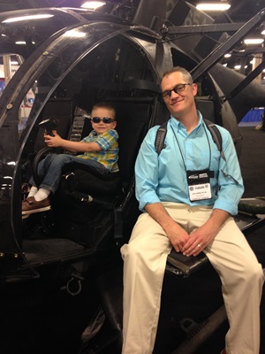 Derek Poor with his son in a helo