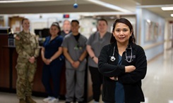 Nurse poses with other nurses for picture