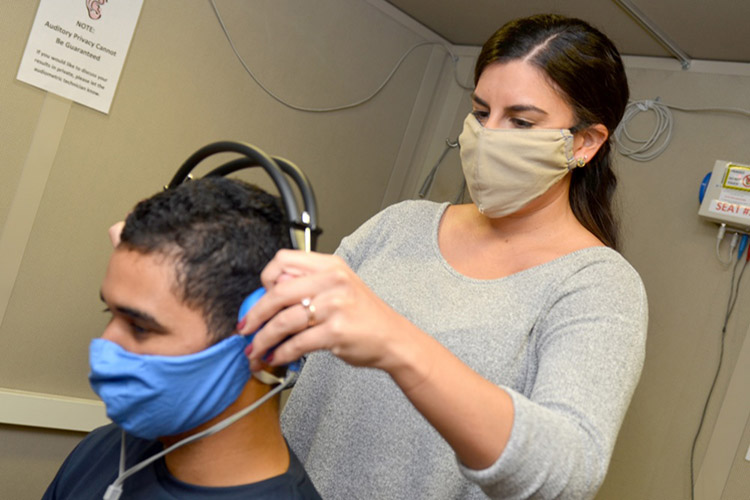 Image of Kori Reese, an audiology technician at Naval Branch Health Clinic Jacksonville’s occupational health clinic, conducts a hearing exam with Airman Diosney Moraga. Naval Hospital Jacksonville and Navy Medical Readiness and Training Command Jacksonville won the Chief of Naval Operation’s Award for Achievement in Ashore Safety (large non-industrial command) for Fiscal Year 2019. (U.S. Navy photo by Jacob Sippel).