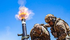 Army Col. Randy Lau fires a 120 mm mortar during a live-fire exercise at Camp Roberts, California, June 15, 2021.