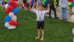 Reeve completes a 2022 summer triathlon. Reeve was assisted by Lt. Col. Cassandra Burns, 88th Medical Group pediatric neurologist, after being diagnosed with a rare case of cerebral folate deficiency at four years old, along with being diagnosed with down syndrome at birth. (Courtesy Photo)