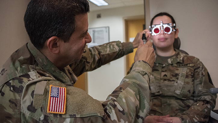 U.S. Army Col. (Dr.) Frank Valentin, chief of ophthalmology, checks a patient for double vision and convergence at Brooke Army Medical Center, Fort Sam Houston, Texas. Recruiting qualified health care providers across the MHS is the first step in the stabilization of MHS, aligning with the MHS Strategy.  (U.S. Army photo by Jason W. Edwards)