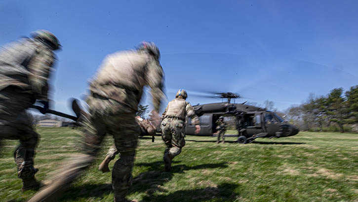 U.S. Army Soldiers load a simulated patient on to a New Jersey National Guard UH-60L Black Hawk helicopter during a combat lifesaver course run by the Medical Simulation Training Center on Joint Base McGuire-Dix-Lakehurst, New Jersey, April 14, 2022.  (U.S. Air National Guard photo by Master Sgt. Matt Hecht)