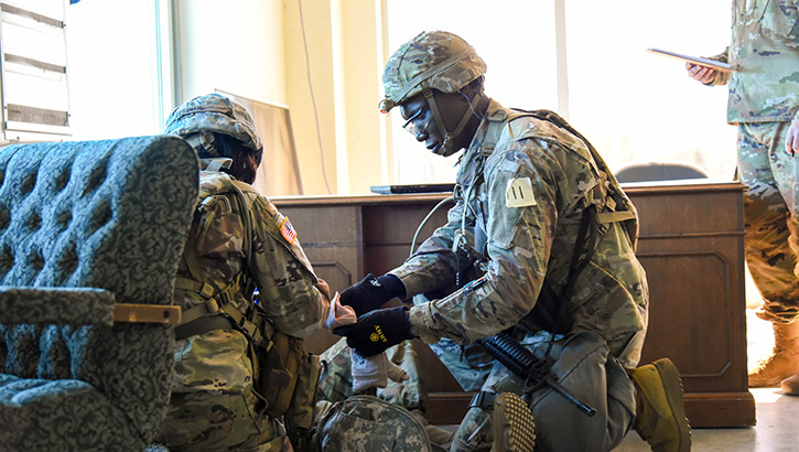 Soldiers with the U.S. Army Medical Research and Development Command perform a battlefield care scenario during the MRDC 2023 Best Squad Competition at Fort A.P. Hill, Virginia, on April 11, 2023.  (Photo: Danae Johnson)