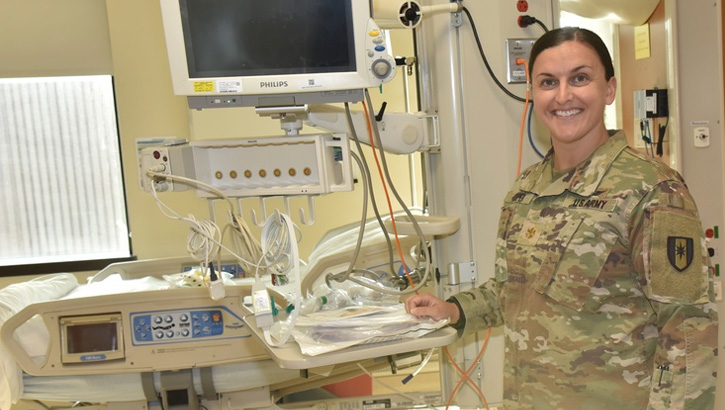 U.S. Army Maj. Abigail Cooper, nursing service chief, conducts a facilities’ check the Medical Care Intensive Unit at Walter Reed National Military Medical Center. After years of honing her craft on assignments in the Middle East and Europe, Cooper arrived at Walter Reed poised to share her energy and insight, overcoming a nursing staff shortage, and keeping morale high in the aftermath of COVID-19. (Photo by James Black, Walter Reed National Military Medical Center)