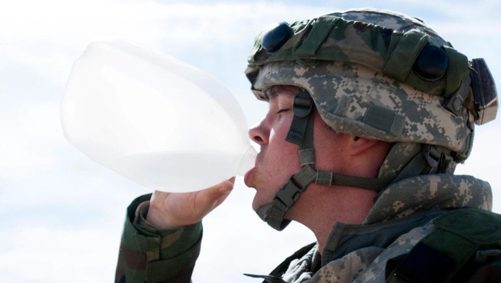 Image of A soldier assigned to the 256th Combat Support Hospital, Twinsburg, Ohio, drinks water from a gallon-sized jug during Combat Support Training Exercise 18-03 at Fort McCoy, Wisconsin, March 26, 2018. The 256th CSH implemented a goal setting competition, dubbed Dandy Camp, to teach and encourage soldiers to monitor their total carbohydrate intake during the field exercise. The overall goal of Dandy Camp is to educate soldiers about healthy eating choices and encourage soldiers to set and meet goals for themselves. .