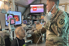 A respiratory therapist visualizes the vocal chords of a patient using an endoscopy tool