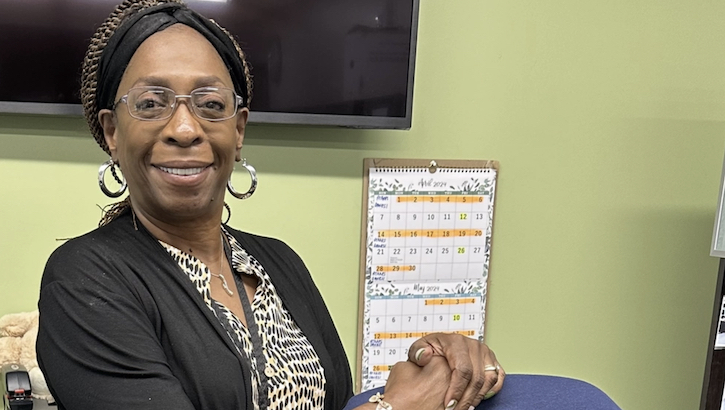 Debra Bartley, an office automation specialist at Naval Branch Health Clinic Kings Bay smiles at her desk