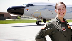 Military personnel standing in front of a plane