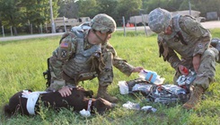 Medics treat a simulated gunshot wound on a K9 Diesel advanced canine medical simulator.