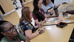 Military personnel volunteers at a middle school back to school event