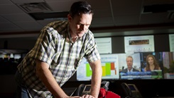 Carl Buckert, audiovisual technician, replaces monitor input cables in the emergency operations center at Brooke Army Medical Center in Fort Sam Houston, Texas, on Oct. 25, 2023. BAMC has been named one of the nation’s “Most Wired” medical facilities for its innovative use of health information technology by the College of Healthcare Information Management Executives. (Photo by Jason W. Edwards/Department of Defense) 