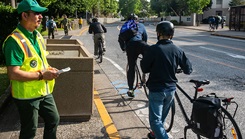 A safety officer overlooks bike riders on a street