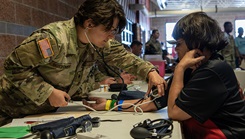 MIlitary medical personnel triages a patient