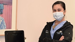 Military health personnel wearing a face mask posing for a picture