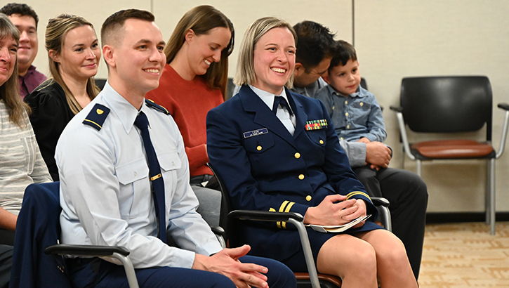 U.S. Coast Guardsmen Lt. Mary Leon and Lt. j.g. Ethan Etlinger, enjoy a laugh during their graduation ceremony from the Carl R. Darnall Army Medical Center Interservice Physician Assistant Program on Feb. 1, 2024.  (Photo by Rodney Jackson/ Carl R. Darnall Army Medical Center)