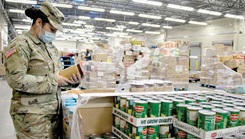 FORT CARSON, Colo. — Spc. Crystal Vice, a veterinary food inspection specialist with Public Health Activity Fort Carson, checks the expiration date on a peanut butter container Oct. 13, 2020, at the Fort Carson Commissary. Food inspectors randomly check food and other items before they’re put on the shelves for sale. (Photo by Eric E. Parris)