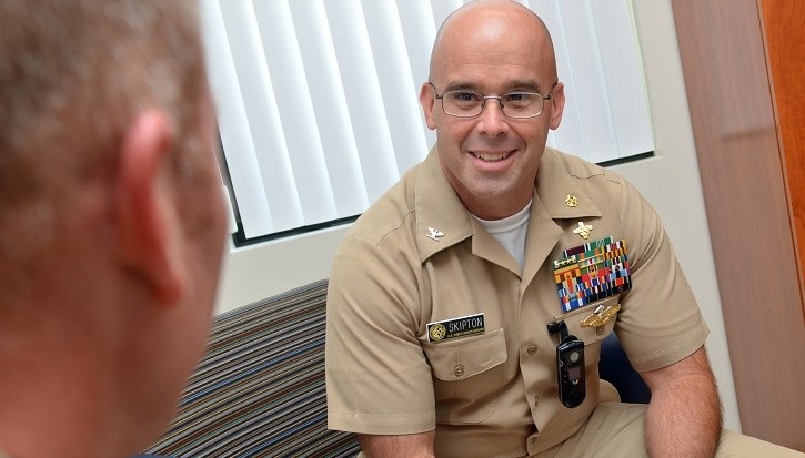 Image of naval captain talking to another military person.