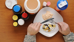 Photo of a dinner plate with food and dietary supplements next to it