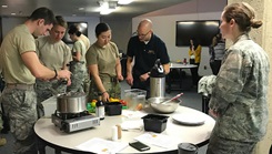 Just about everyone has a connection with food. It’s a fundamental need, and there’s a science to food that can help people. Dr. Jonathan Scott, Uniformed Services University professor, goes over a recipe with a group of students at the USU culinary lab. The small dining room at USU is used for this experiential opportunity. (Photo courtesy of Dr. Jonathan Scott)