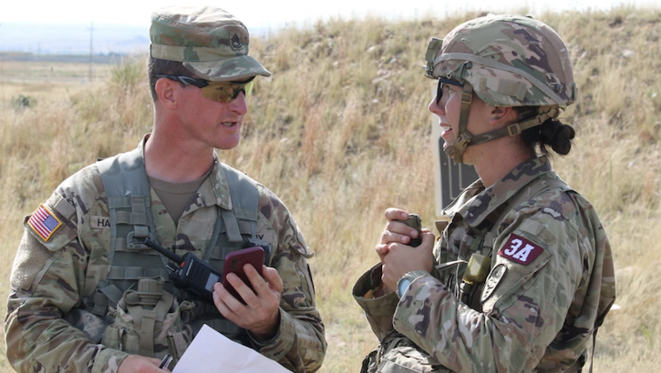 Sgt 1st Class Zachary Harrison, an event planner for the 2023 Medical Readiness Command-West Best Medic Competition, provides details of an event to a Best Medic Competitor. Harrison is assigned to the Evans Army Community Hospital Radiology Department. (Photo By Gino Mattorano)