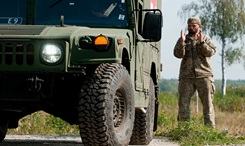 A Ukrainian Soldier uses hand signals during a ground guide exercise of field litter ambulance familiarization on the driving range at Yavoriv Training Area, Ukraine. A team of medics and a mechanic from 557th Medical Company and 212th Combat Support Hospital are working together to conduct field littler ambulance and medical equipment  familiarization with the Ukrainian military. (U.S. Army photo by Capt. Jeku)