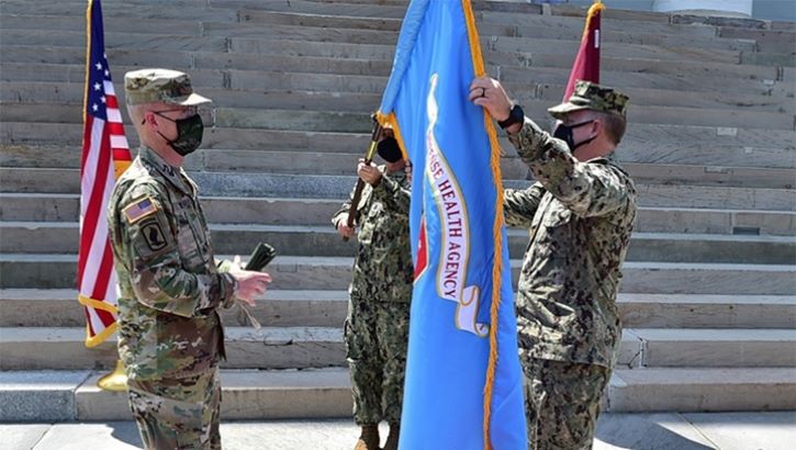 The unfurling of the DHA flag during a ceremony