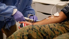 Military personnel donating blood