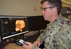 Computer screen with doctor examining image