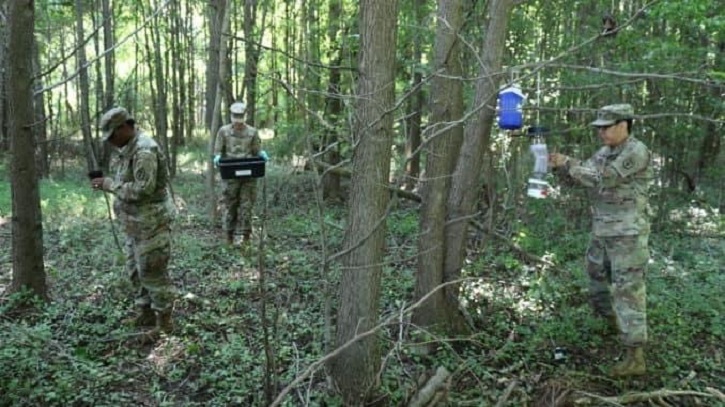 Group of people in forest gathering samples