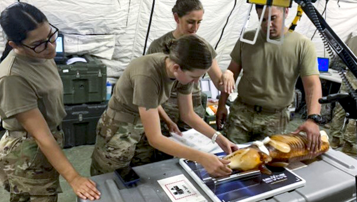 Military medical personnel testing vet x-ray device