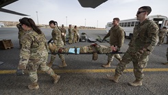 U.S. Air Force Airmen from the 386th Expeditionary Medical Squadron and the 405th Expeditionary Air Evacuation Squadron move a litter onto a C-130J Super Hercules at Ali Al Salem Air Base, Kuwait. (U.S. Air Force photo by Senior Airman Nicholas Larsen)