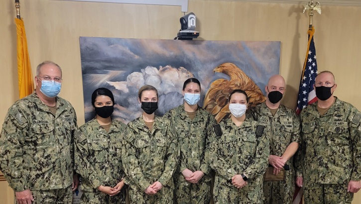 Military personnel wearing face mask posing for a picture