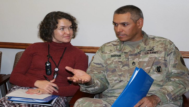 Sgt. 1st Class Mario Fabian, the noncommissioned officer in charge of the Evans Army Community Hospital Warrior Care Clinic, and Meghan Spain, a registered nurse in the EACH OB/GYN Clinic, practice lessons learned during Peer Support Program training. 
