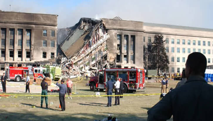 Onlookers view the collapsed side of the Pentagon building.