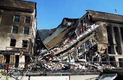 A section of the Pentagon lies in ruins following the deadly Sep. 11 terrorist attack in which a hijacked commercial airliner was crashed into the Pentagon. American Airlines FLT 77 was bound for Los Angeles from Washington Dulles with 58 passengers and 6 crew. All aboard the aircraft were killed, along with 125 people in the Pentagon. (U. S. Naval photo by Photographer's Mate 1st Class Michael W. Pendergrass)