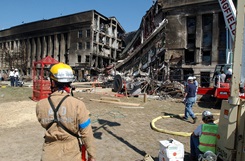 A fire fighter from Arlington County, Fire Department surveys the scene during rescue and recovery efforts following the deadly Sep. 11 terrorist attack in which a hijacked commercial airliner was crashed into the Pentagon. American Airlines FLT 77 was bound for Los Angeles from Washington Dulles with 58 passengers and 6 crew. All aboard the aircraft were killed, along with 125 people in the Pentagon. (U.S. Naval photo by Photographer's Mate 1st Class Michael W. Pendergrass.)