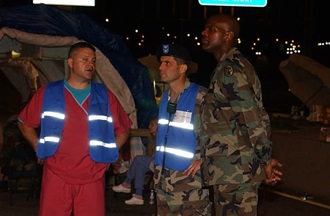 Link to Photo: Dr. James Geiling (center), at the time an Army colonel in charge of the Pentagon's DiLorenzo Tricare Health Clinic, talks with local first responders and senior military commanders after the terrorist attack on the Pentagon on Sept. 11, 2001.