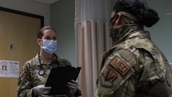 Photo of two military women talking.