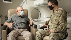 Military medical personnel consults with Harold G. Overstreet, retired Sgt. Maj. of the Marine Corps