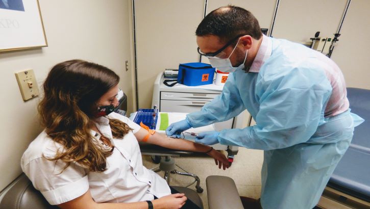 Image of Woman gets blood drawn.