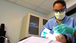 U.S. Air Force Major Rachael Parrish, 20th Dental Squadron general dentist, performs an oral exam on Airman 1st Class Amie Bickford, 20th Equipment Maintenance Squadron munitions technician at Shaw Air Force Base, South Carolina, March 13, 2017. Airmen assigned to the 20th DS are tasked with ensuring airmen and soldiers on base meet all dental class requirements for deployment.