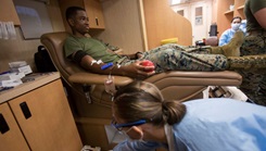 Military personnel donating blood