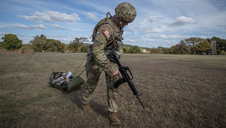 U.S. Army Sgt. Henry Gross, a radiology specialist, drags a simulated patient to safety during Brooke Army Medical Center’s NCO and Soldier of the Year competition at Camp Bullis, Texas, in 2019. The Defense Health Agency’s Virtual Education Center will provide service members with the health and medical information they need to stay ready for the mission.  (U.S. Army photo by Jason W. Edwards)