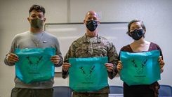 Participants in the Storytellers event standing side by side wearing face masks