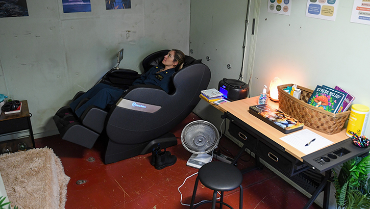 U.S. Navy Lt. Cmdr. Katie Lee, an emergency room doctor, relaxes in a massage chair in the resiliency room aboard the hospital ship USNS Mercy underway in the Pacific Ocean, as part of Pacific Partnership 2024-1, on Jan. 23, 2024. (Photo by U.S. Navy Mass Communication Specialist 3rd Class Justin Ontiveros)
