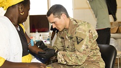 Military medical personnel drawing blood